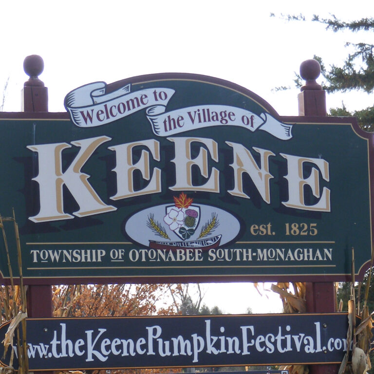 Sign reading Welcome to the Village of Keene, with thekeenepumpkinfestival.com listed below