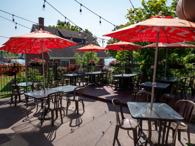An outdoor patio with red umbrellas